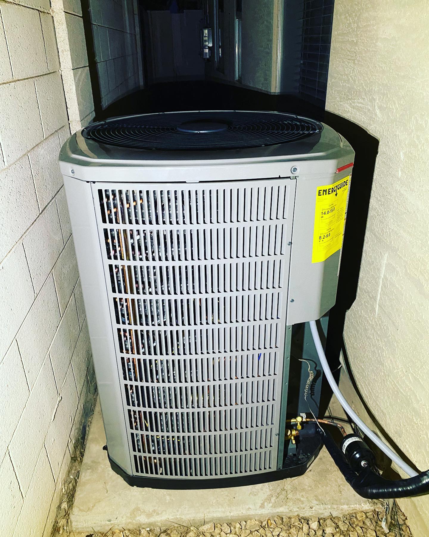 A newly installed high efficiency condenser with its EnergyGuide label still attached